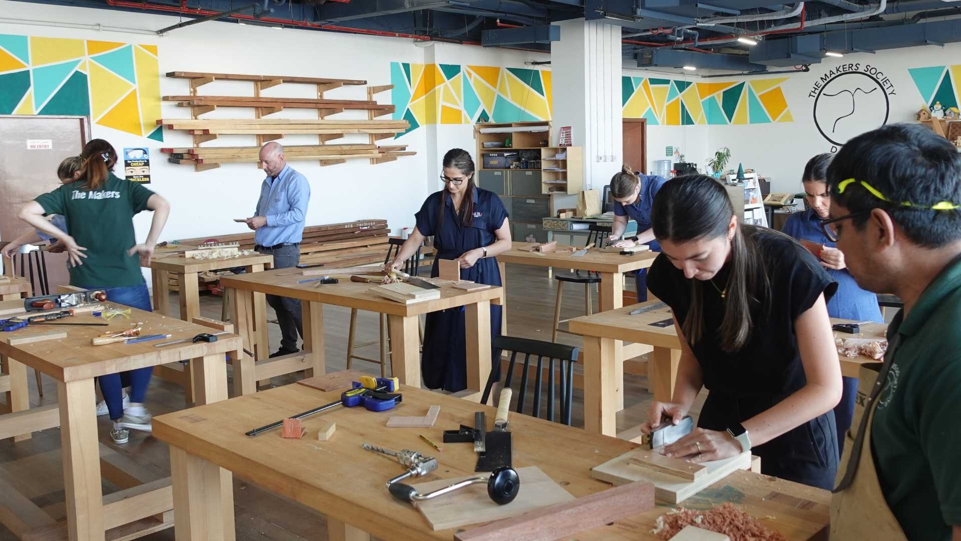 Small beginner woodworking class at The Makers Society Dubai focused on safe, individual instruction at workbenches