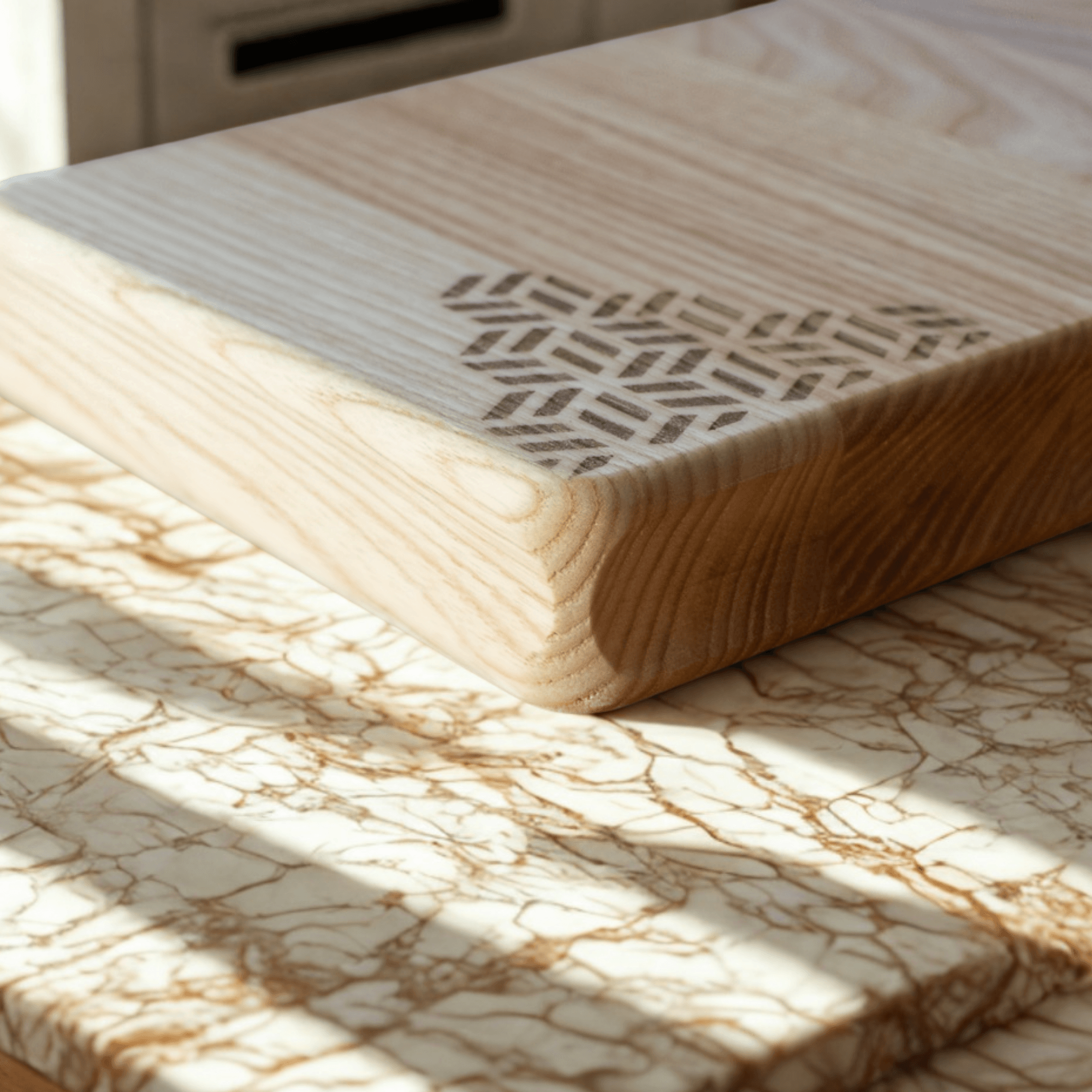 Close-up of a handcrafted wooden serving board with geometric inlay on marble surface in natural light