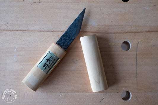 Kakuri 24mm Japanese woodworking carving knife with wooden handle and cap on workbench
