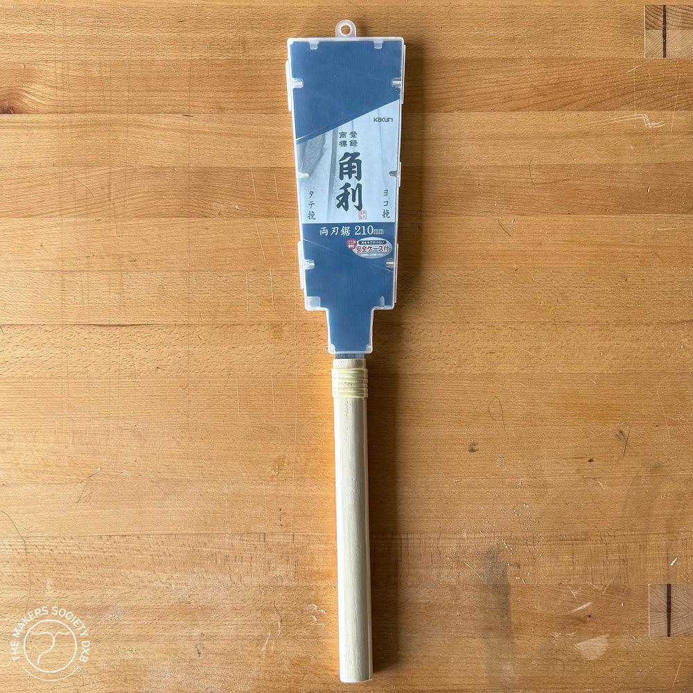 Kakuri 210mm double-edge razor saw with wooden handle on a wooden surface, woodworking tool