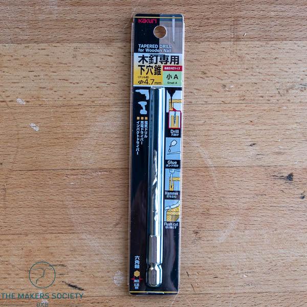 Kakuri tapered drill bit for wooden nails, 4.7mm, packaged on wooden surface, woodworking tool