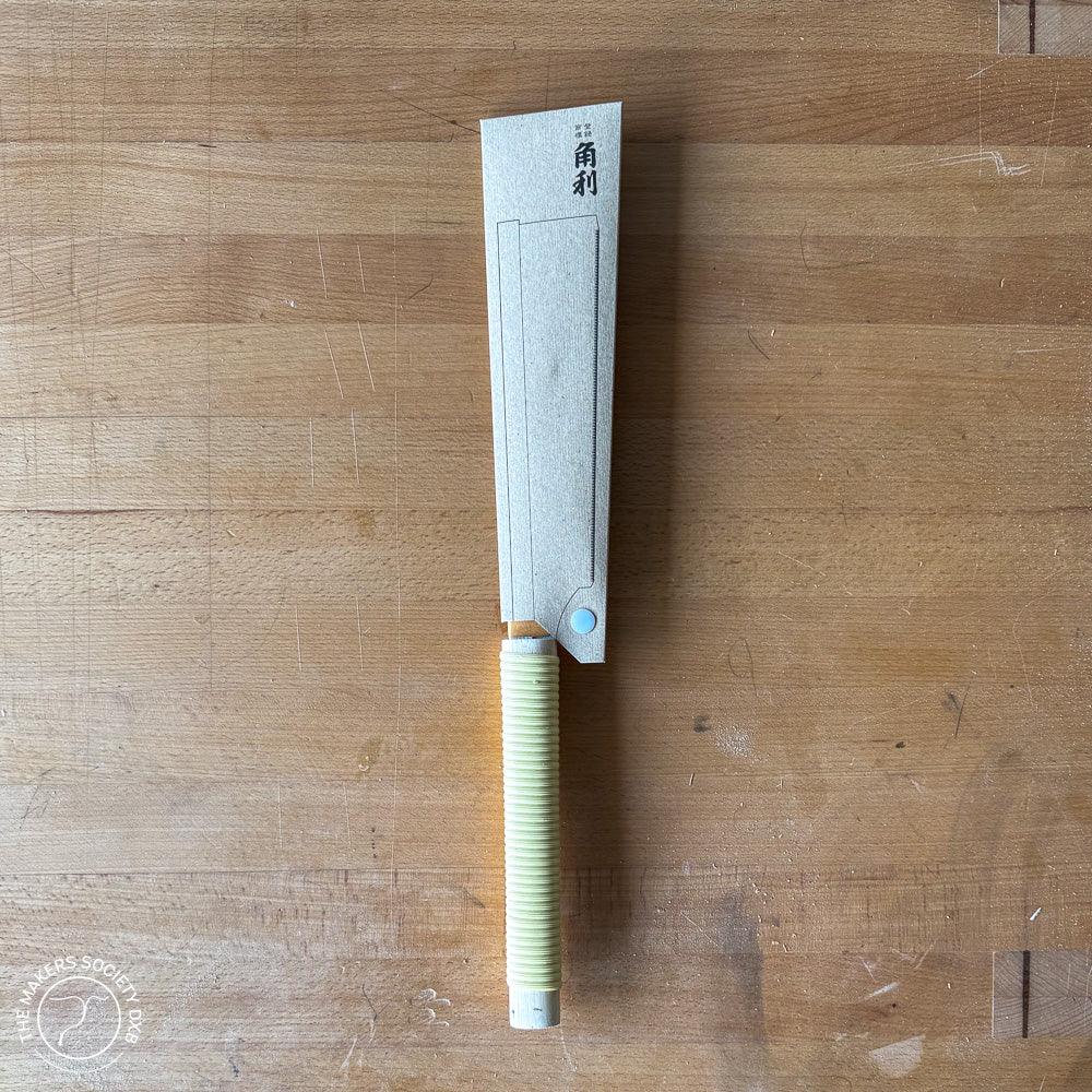 Japanese Kakuri Dozuki saw with 150mm blade on wooden surface, wrapped handle, woodworking tool