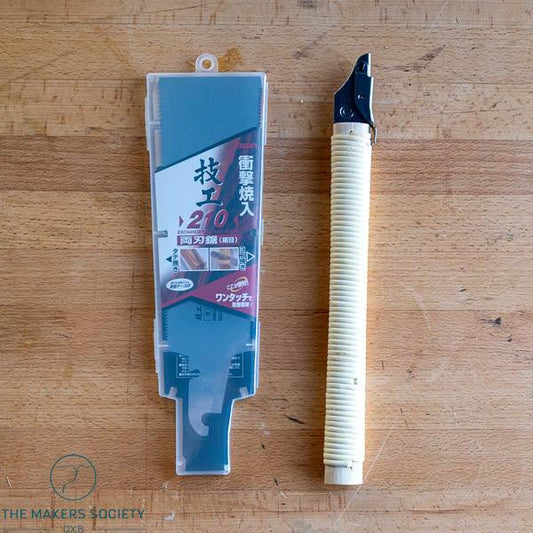 One-touch spare blade for Type Ryoba saw 210mm with protective case on wood surface