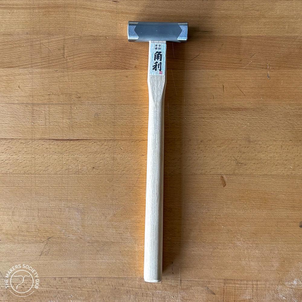 Kakuri Square Head Hammer 225g with silver metal head and wooden handle on wooden surface