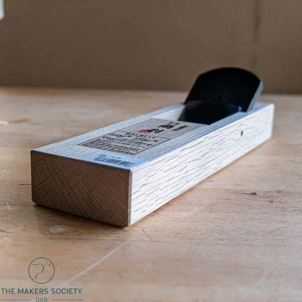 Japanese smooth plane with white oak body on wooden surface, premium woodworking tool