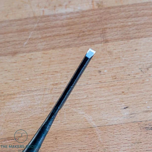 6mm white steel wood chisel on wooden surface with The Makers Society logo