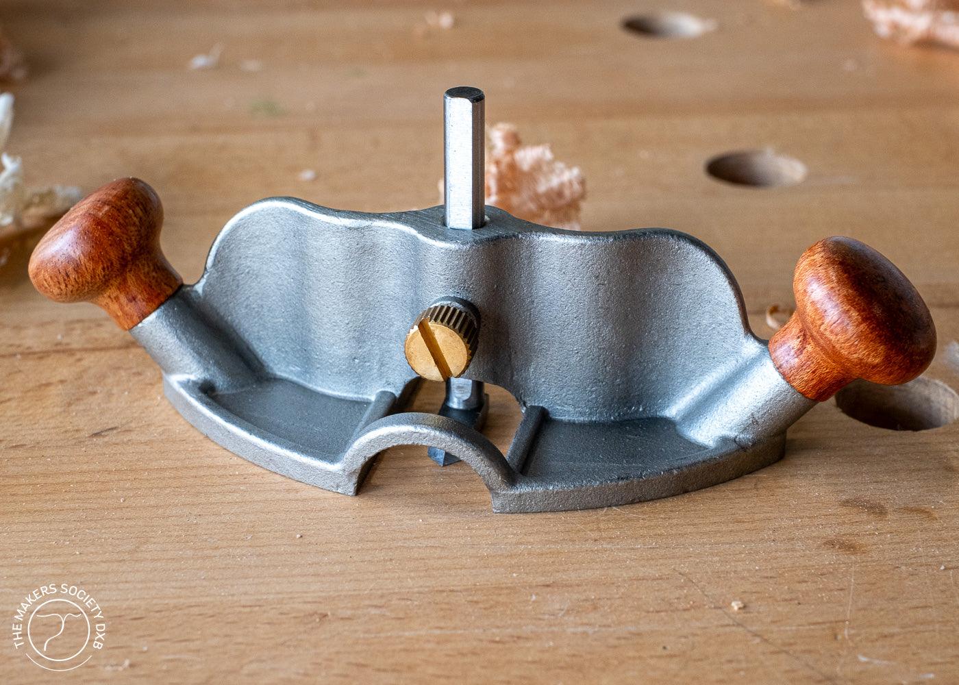 Luban Router Plane with wooden handles on a woodworking bench with wood shavings