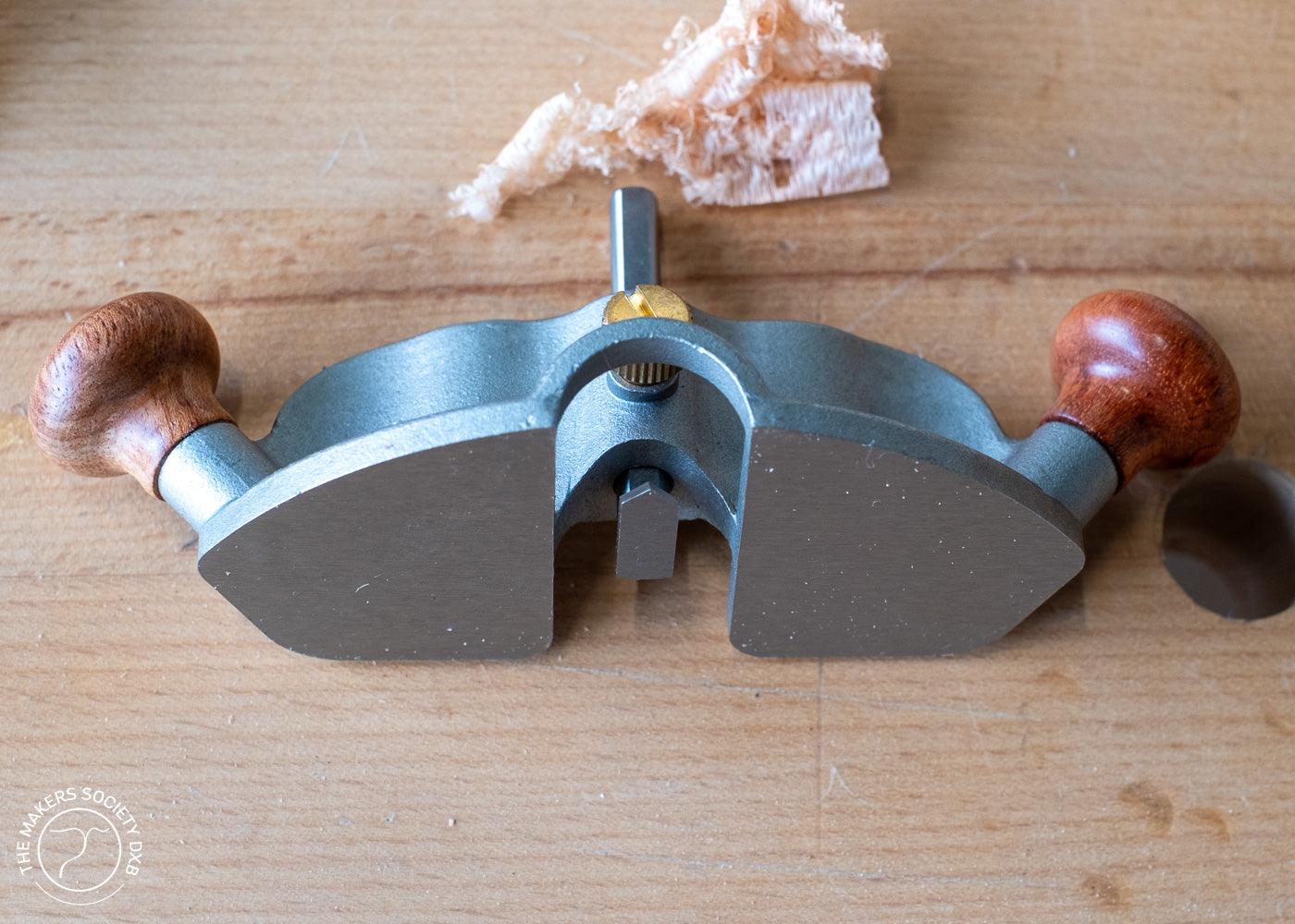 Luban Router Plane with wooden handles on a wooden workbench with wood shavings
