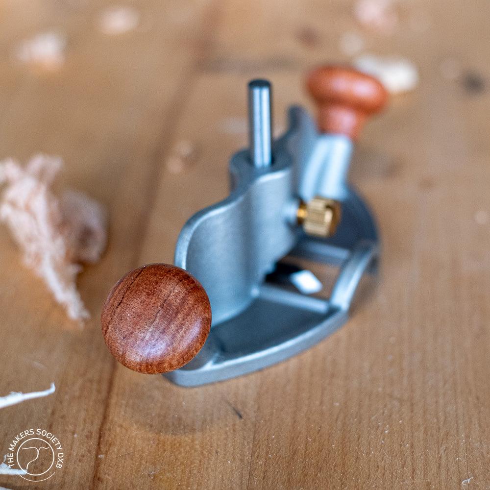 Luban router plane with wooden handles on a woodworking surface with wood shavings