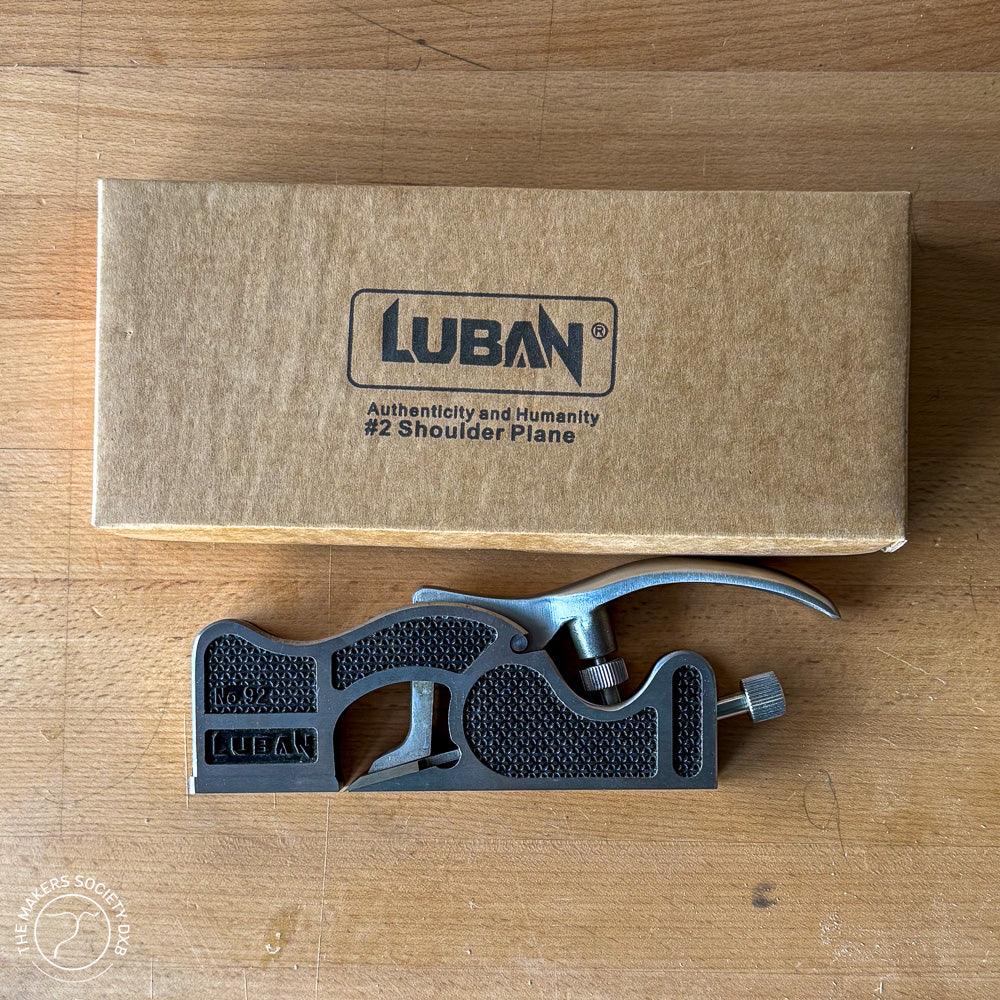 Luban #2 Shoulder Plane woodworking tool with black handle, placed on wood surface next to brown Luban box