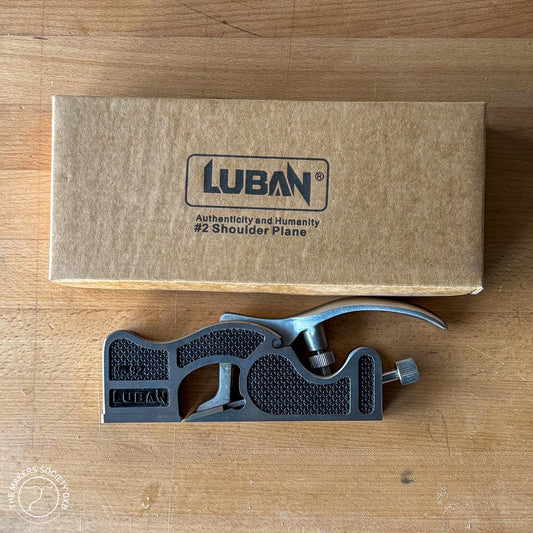 Luban #2 Shoulder Plane woodworking tool with black handle, placed on wood surface next to brown Luban box