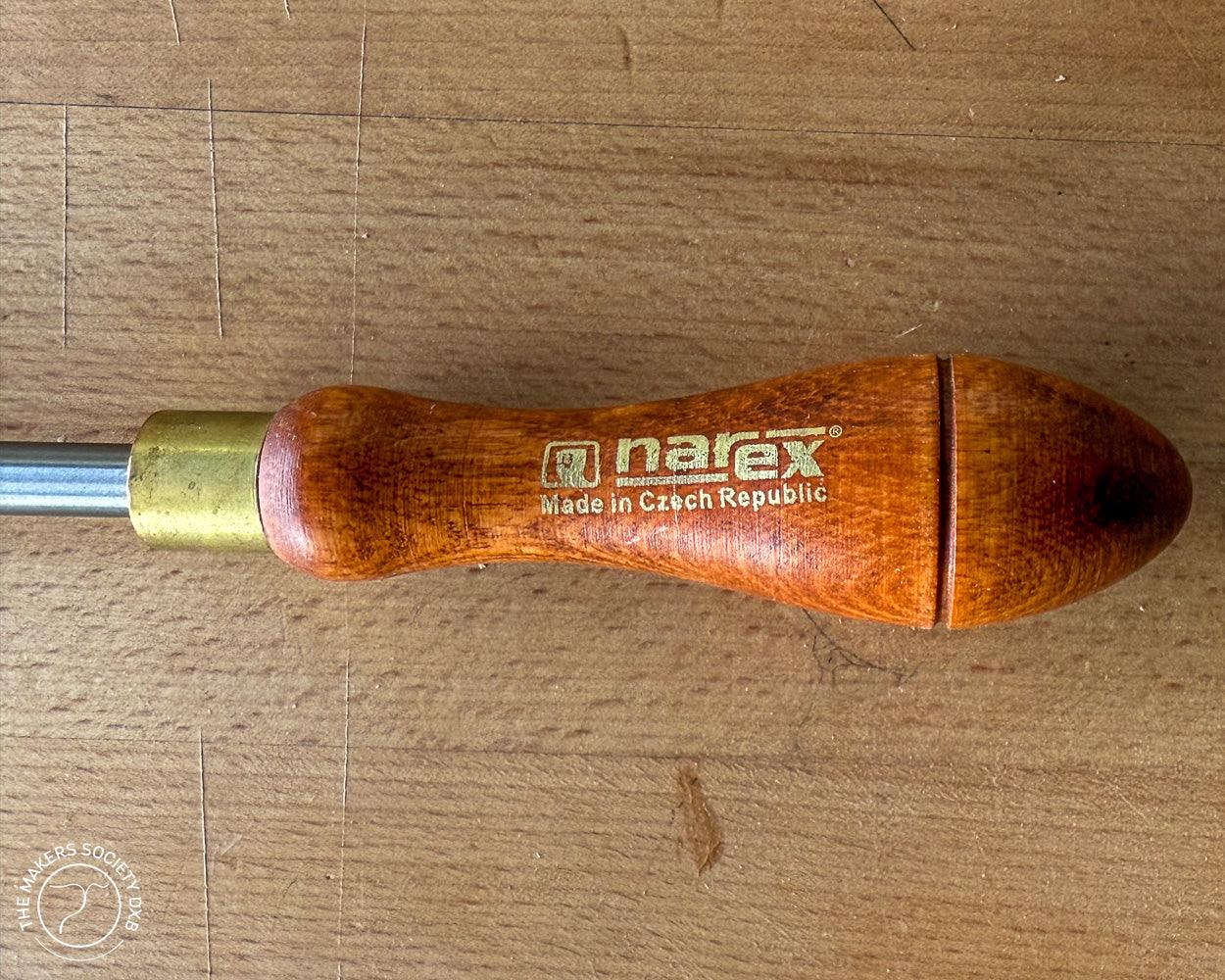 Close-up of Narex wooden burnisher handle made in Czech Republic on a wooden surface