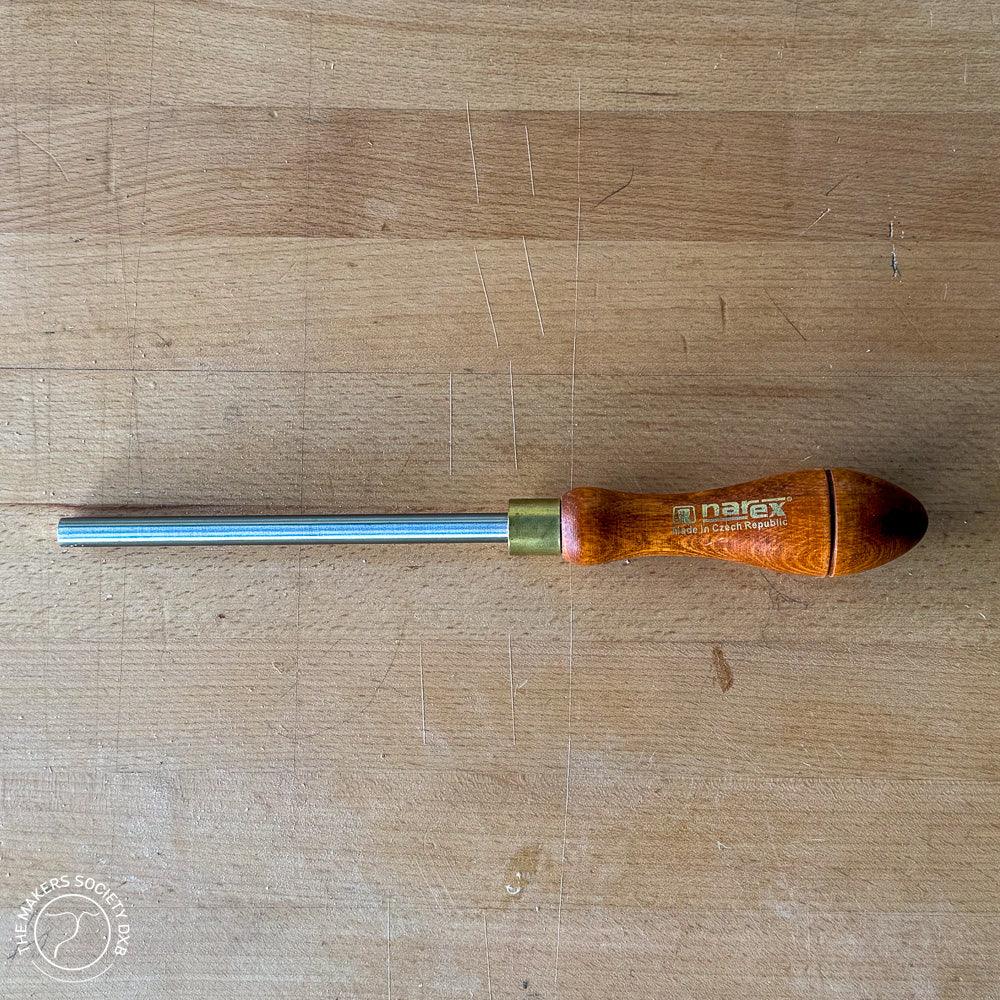 Narex wood burnisher with polished steel blade and wooden handle on wooden surface