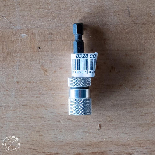 Narex magnetic holder drill bit adapter with barcode on wooden surface, woodworking tool