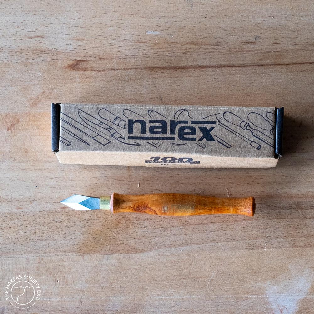 Narex marking knife with wooden handle next to branded cardboard box on wood surface