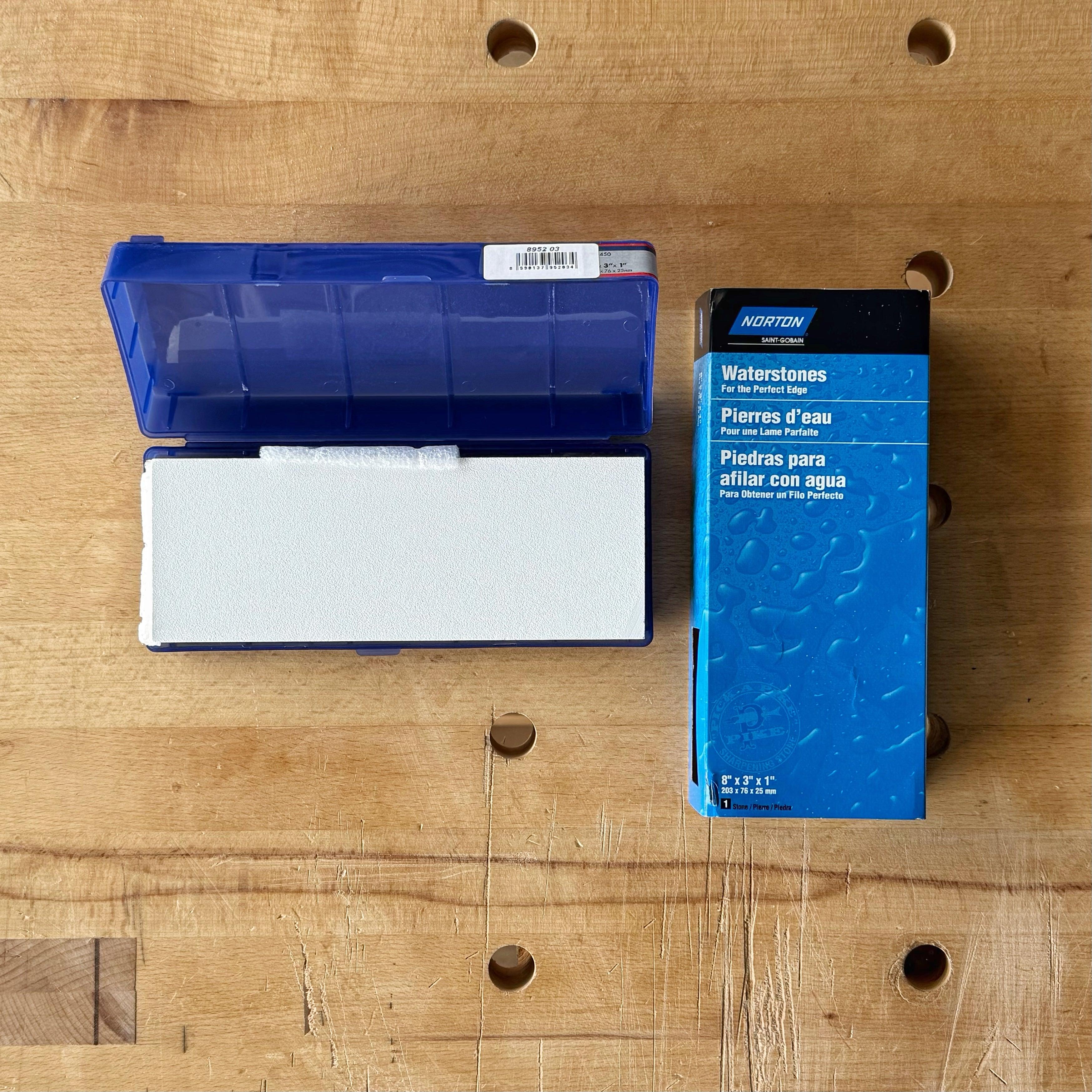 Norton Waterstone sharpening stone in blue case with packaging on wooden workbench