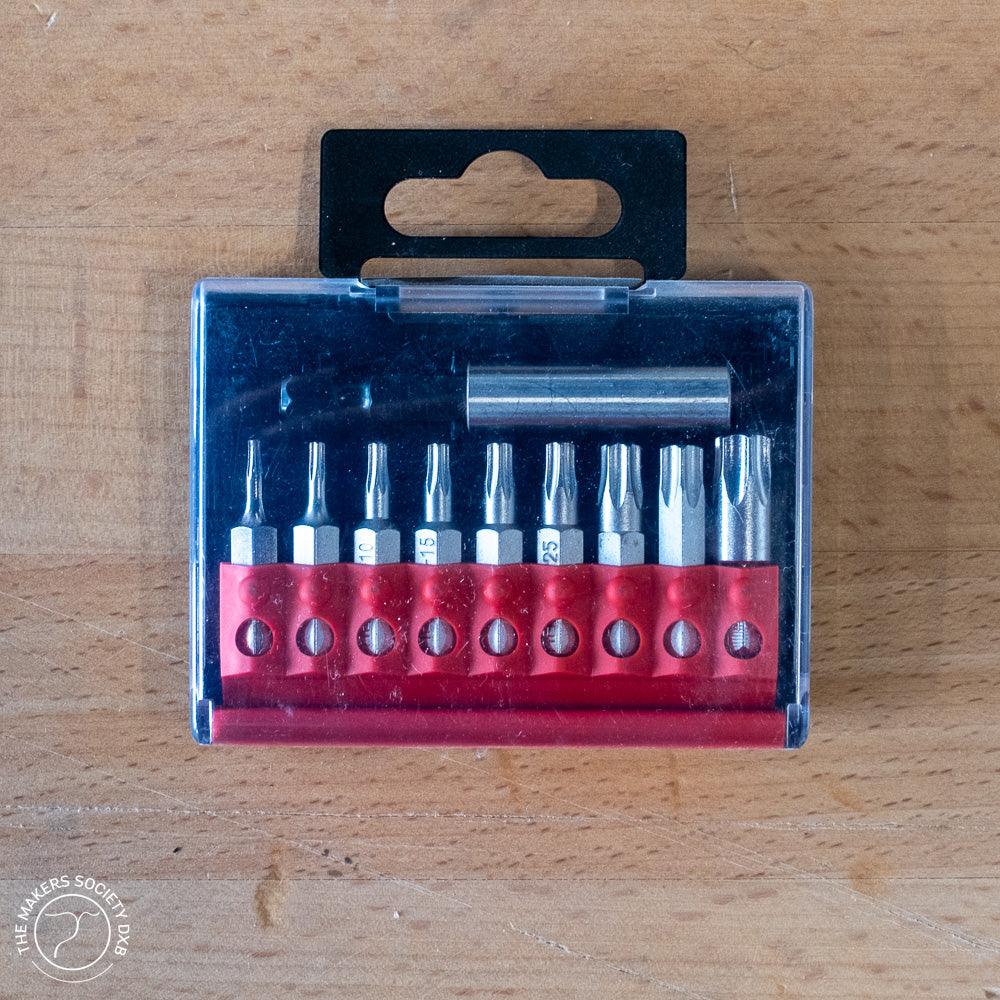 Set of 10 Narex screwdriver bits with magnetic holder in transparent plastic case on wooden surface