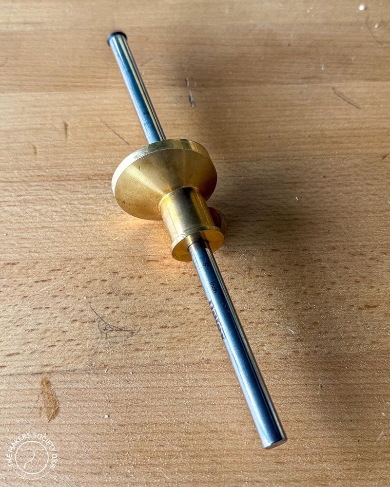 Narex brass and steel wheel marking gauge tool on wooden surface for woodworking precision