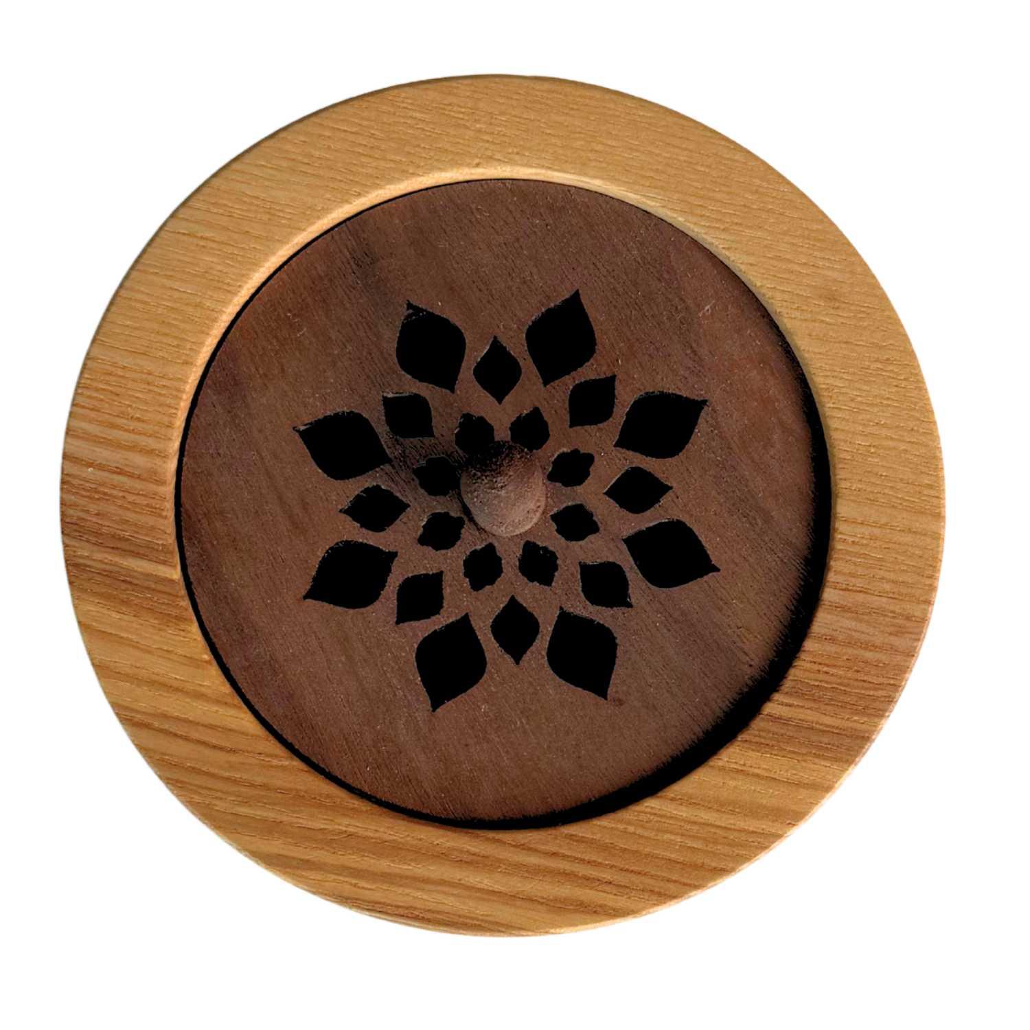 Round wooden incense holder with laser-cut flower pattern and knob in center