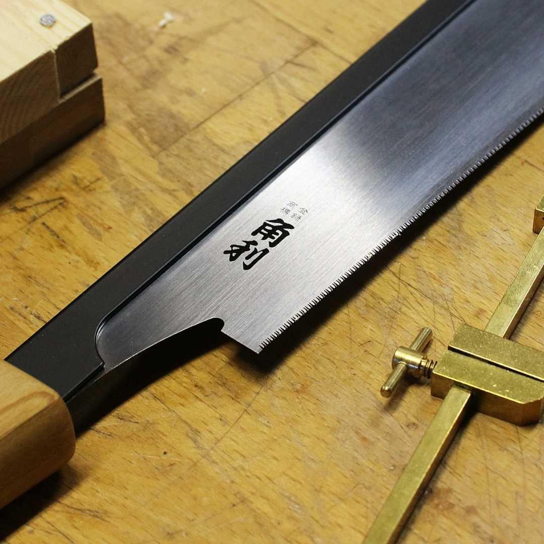 Kakuri Sakura premium Japanese precision tenon saw with wooden handle on a workshop wooden surface