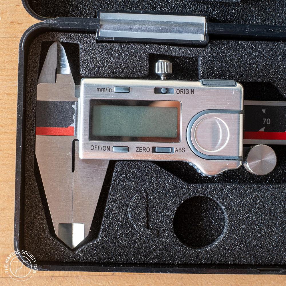 Absolute Zero digital caliper in a black foam case, precision measuring tool for woodworking