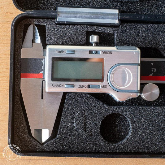 Absolute Zero digital caliper in a black foam case, precision measuring tool for woodworking