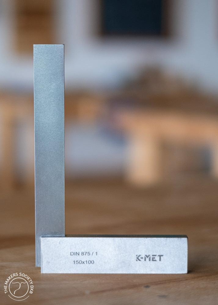 K-MET precision universal square 150x100mm with DIN 875/1 metal carpenter tool on wooden surface