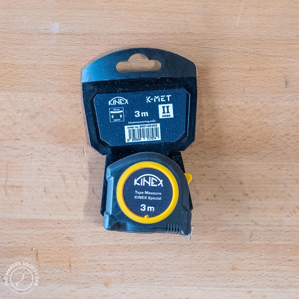 KIMEX 3m tape measure with black and yellow casing on a wooden surface, woodworking tool