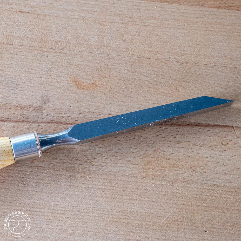 Narex mortise chisel with wooden handle on wooden surface, woodworking tool for precise joinery