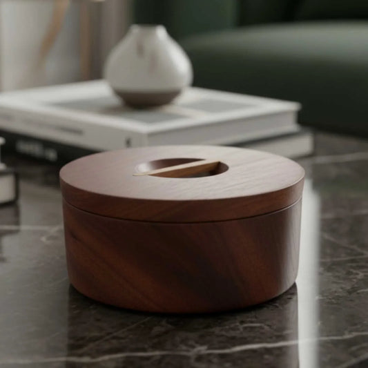 Round Japanese-style dark wooden box with a lid, placed on a marble surface in a modern living room
