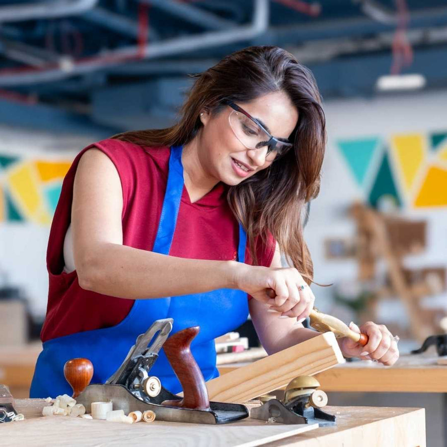 Woman working with tools in a workshop setting