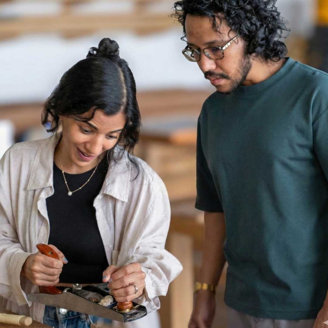 Two people working together on a project in an indoor setting
