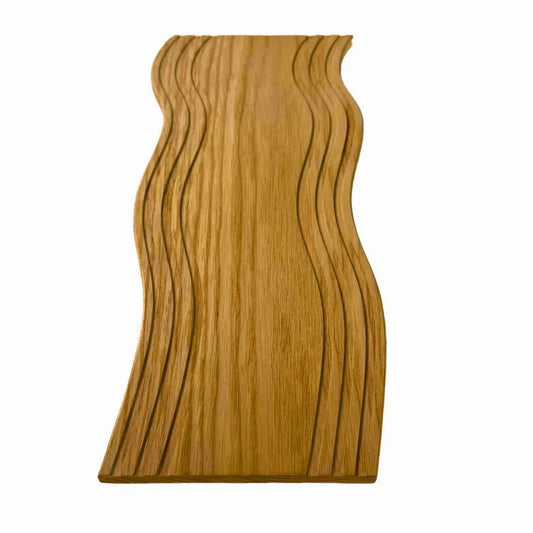 Handcrafted wooden serving board with carved wave patterns, smooth finish, natural wood grain