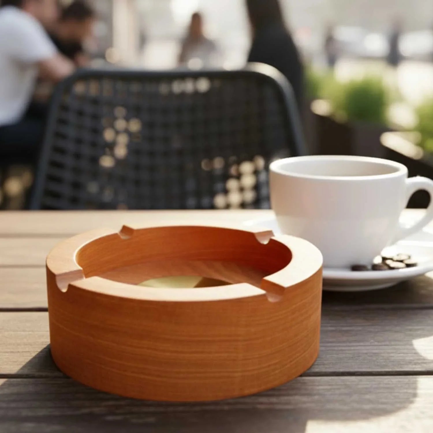 Handcrafted Zelkova Japanese ashtray on wooden table next to white coffee cup with saucer