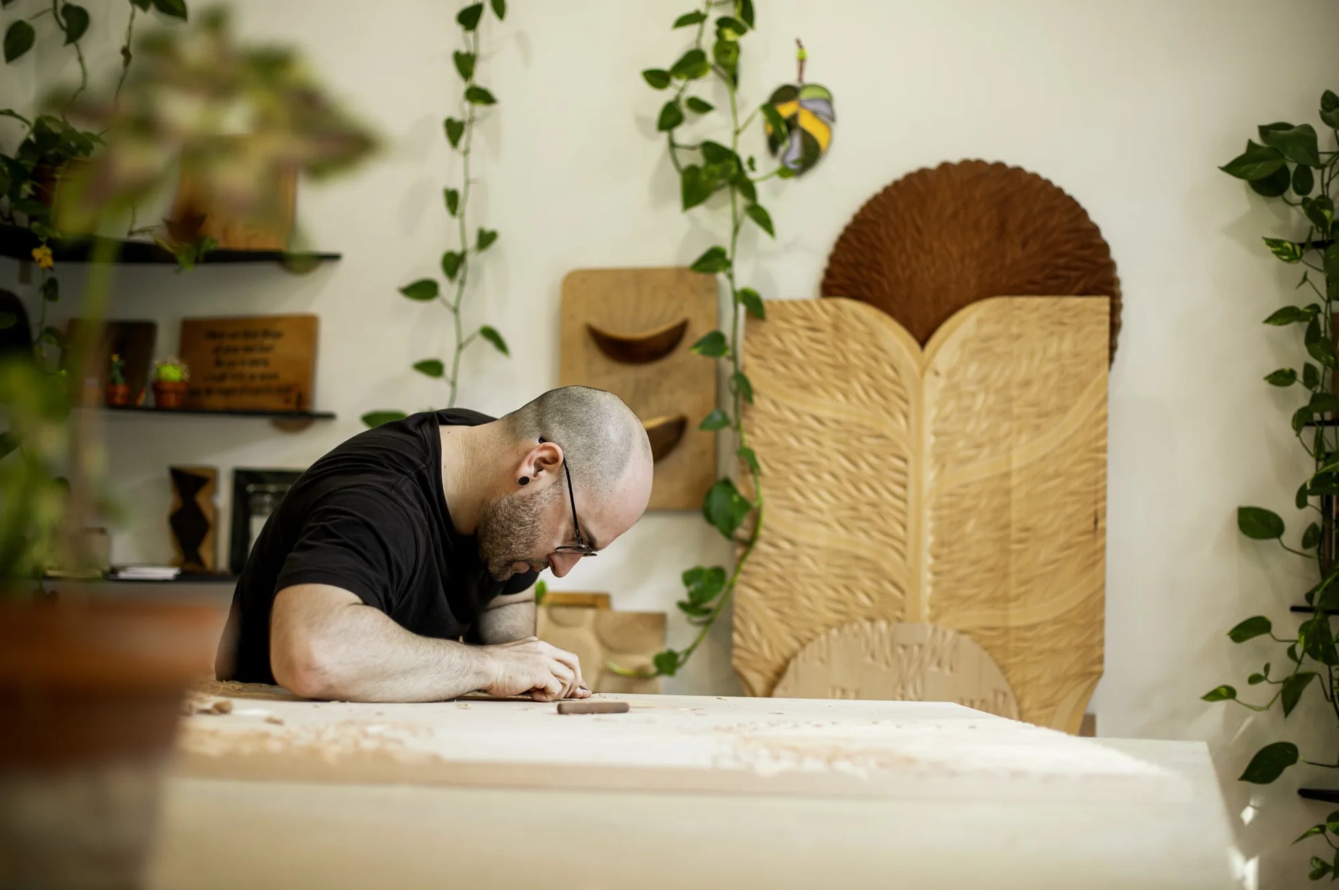 Bernat Mercader hand-carving a large chip-carved panel in his studio