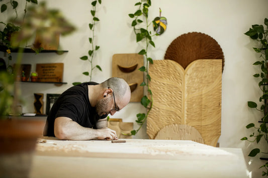 Bernat Mercader hand-carving a large chip-carved panel in his studio
