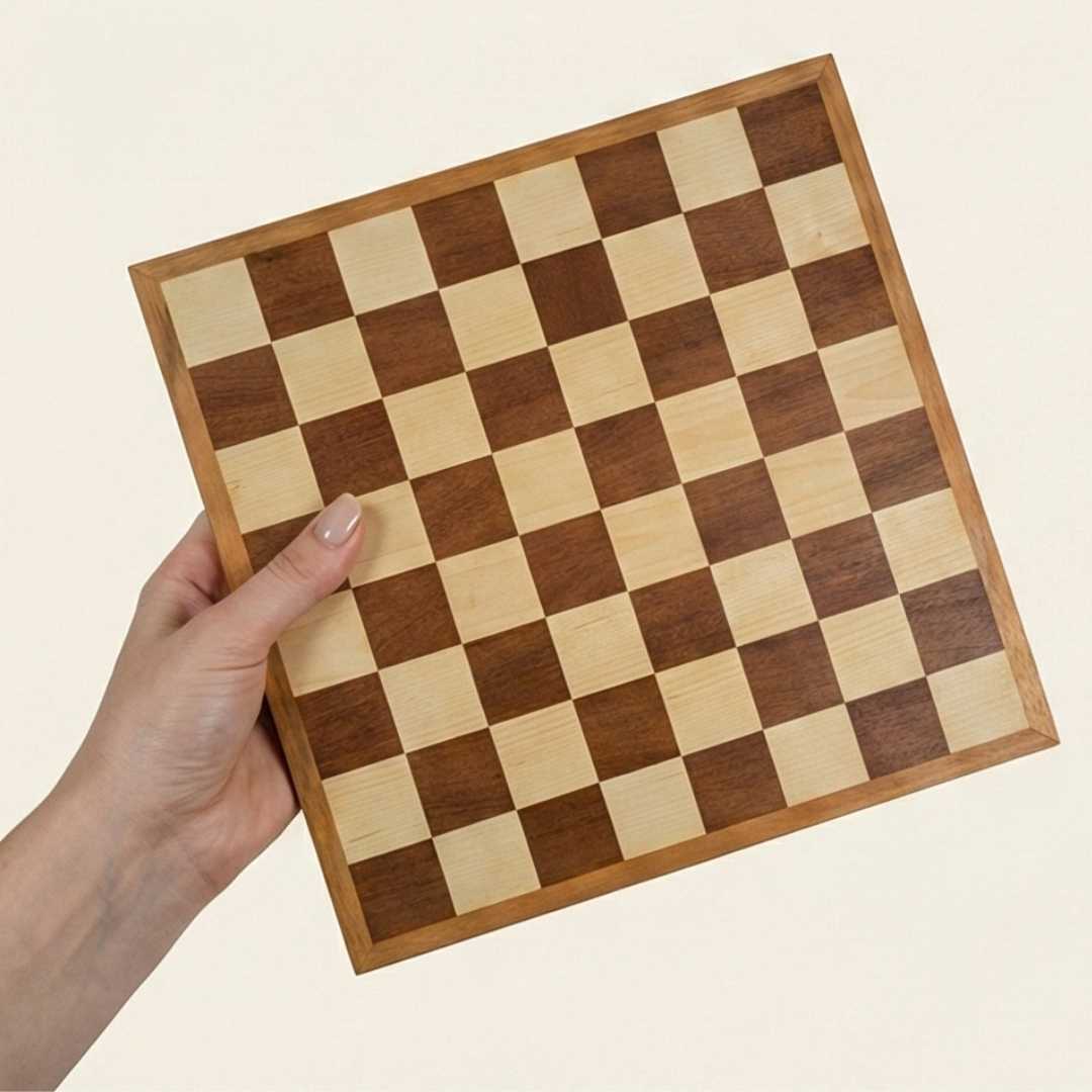 Wooden checkered board held by a hand on a beige background