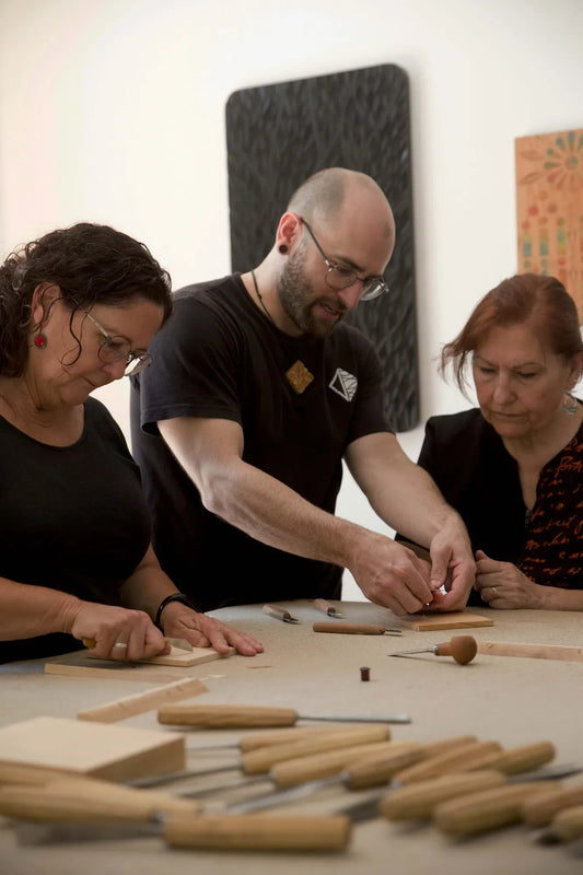 Bernat Mercader teaching two makers at a chip carving workshop