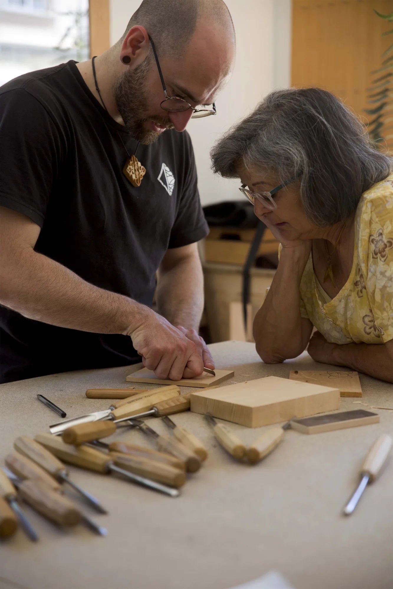 Bernat Mercader giving one-to-one chip carving guidance to a maker