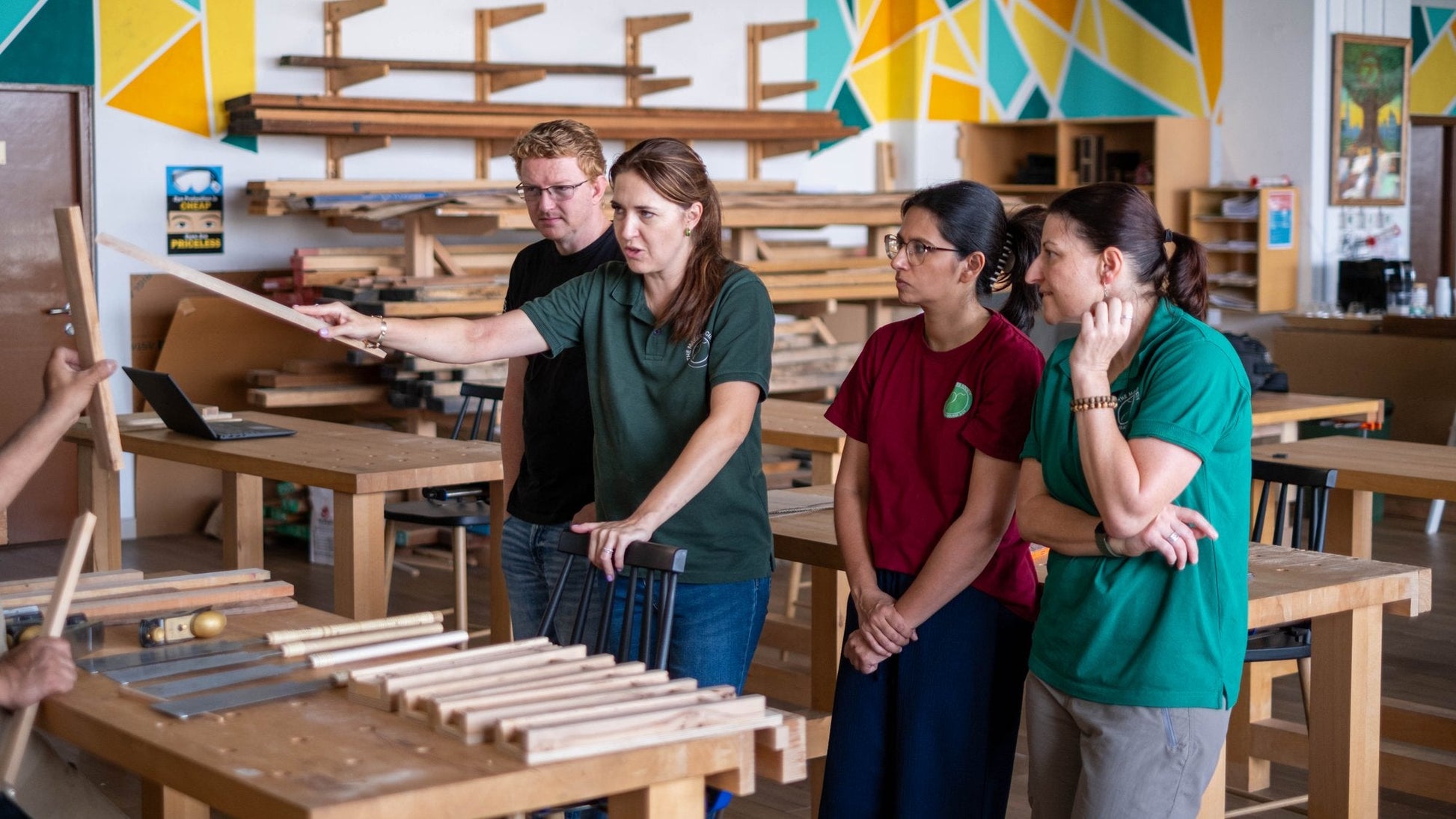 Group holding a rack of chopstick blanks made during a workshop session in Dubai