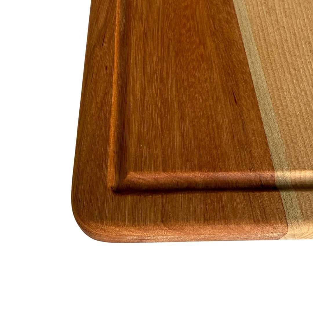 Close-up of handcrafted long grain wooden cutting board with smooth rounded edges from The Makers Society