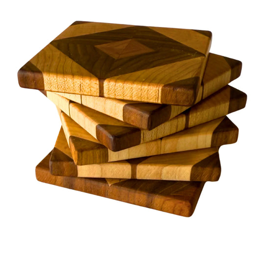 Stack of handmade wooden diamond pattern coasters with mixed wood tones from The Makers Society Shop