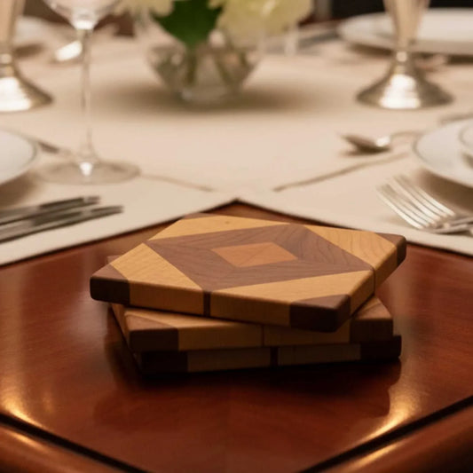 Stack of handmade wooden diamond-pattern coasters on a polished table at a formal dining setup