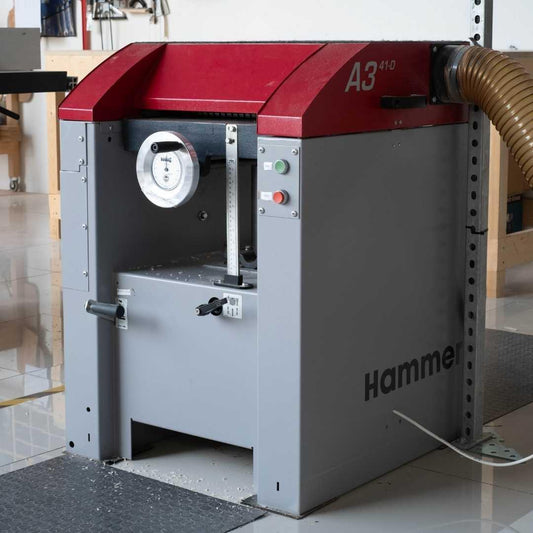 Red and gray machine with 'Hammer' branding on a tiled floor.
