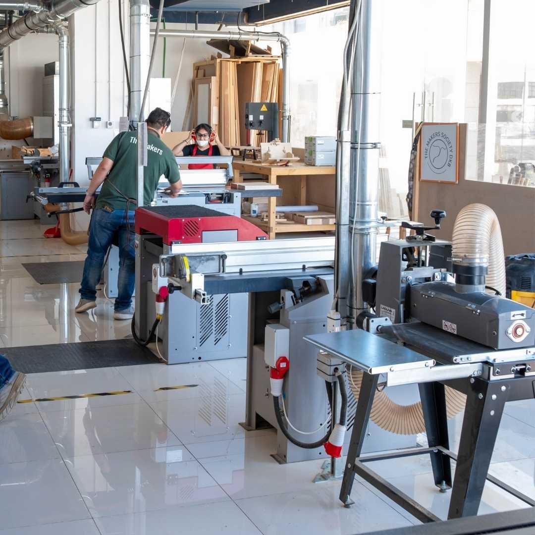 Woodworking shop with machinery and workers in a modern facility