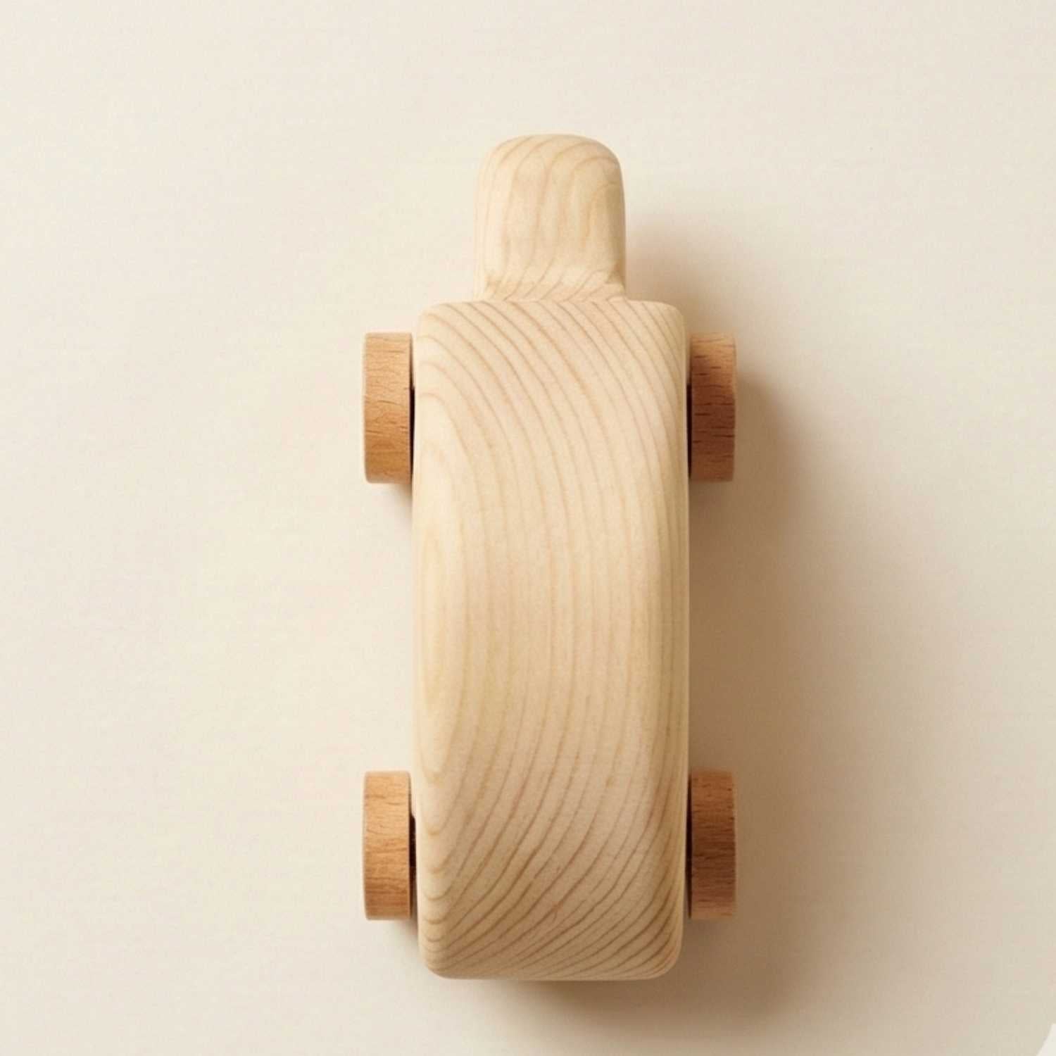 Wooden toy car on a beige background