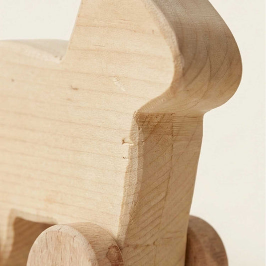 Close-up of a wooden toy horse on a light beige background