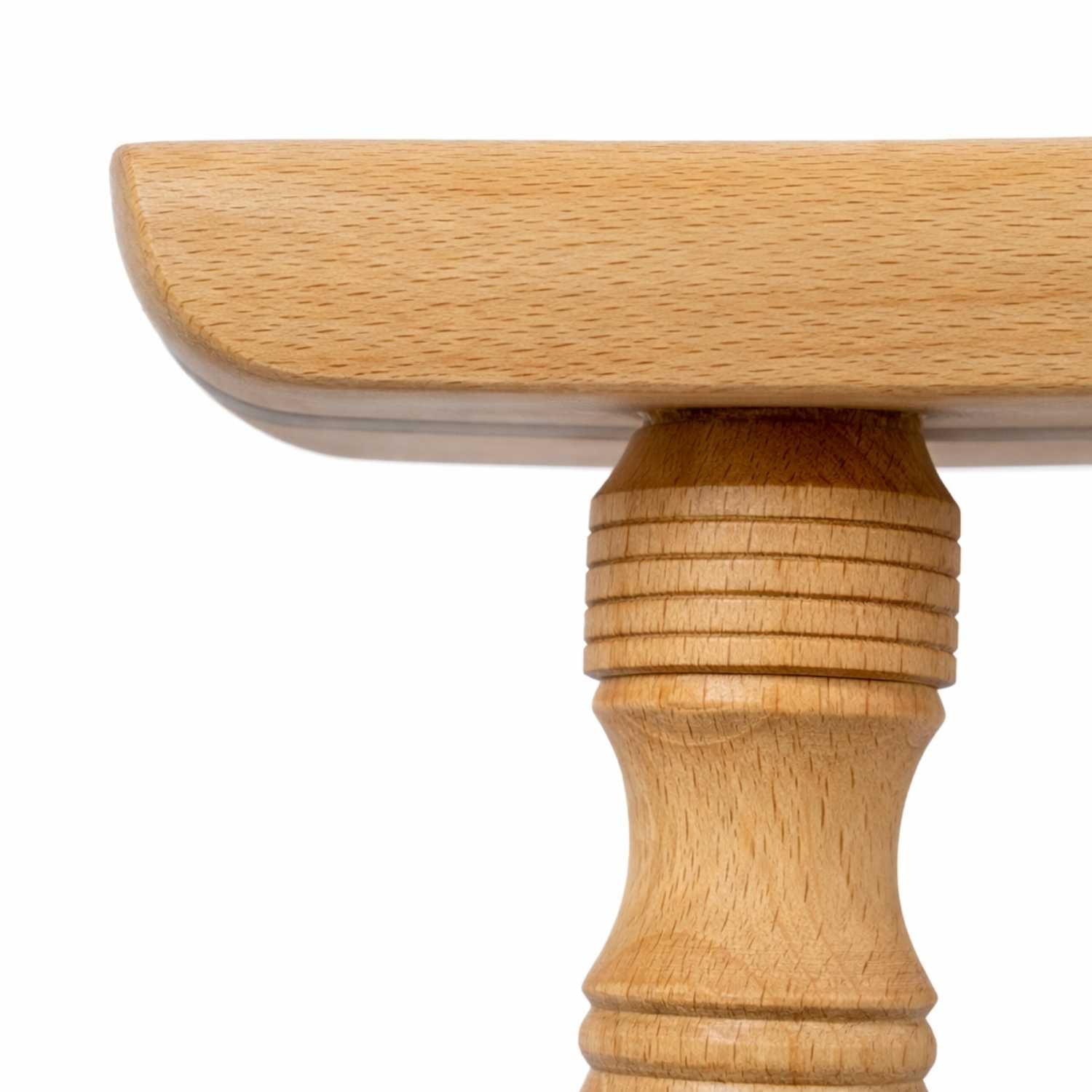 Close-up of a woodturned stool leg and seat joint, highlighting traditional woodworking craftsmanship by The Makers Society in Dubai