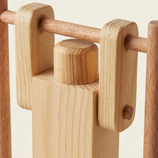 Close-up of handmade wooden acrobat toy, natural wood finish, The Makers Society Dubai