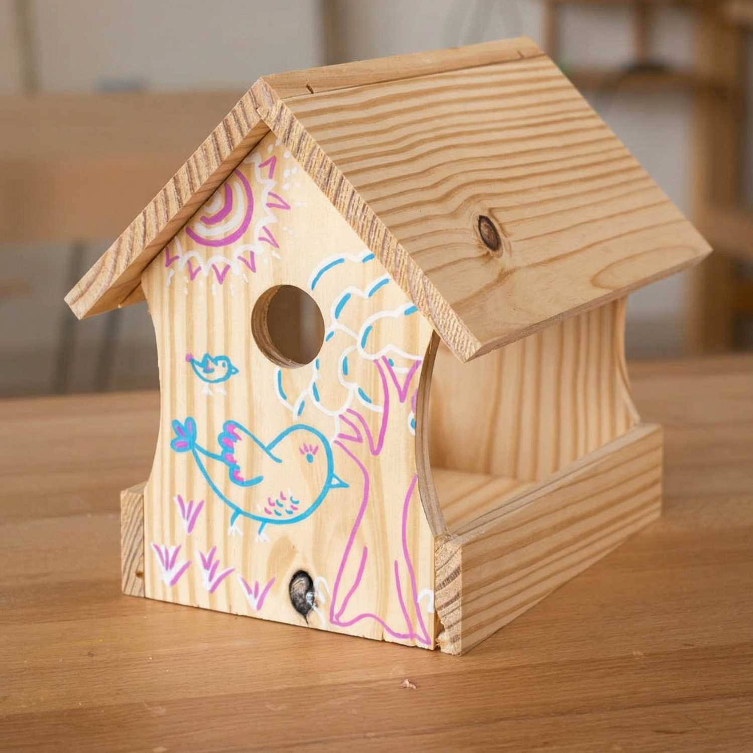 Finished wooden birdhouse from The Makers Society kids woodworking kit with hand-decorated details